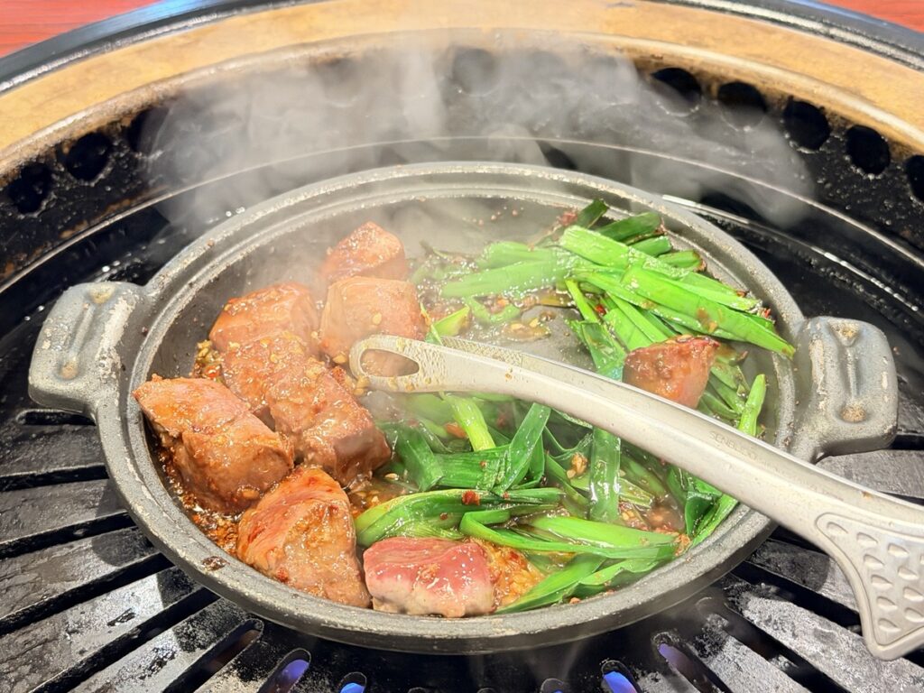卓上の鉄板で焼いているレバニラ